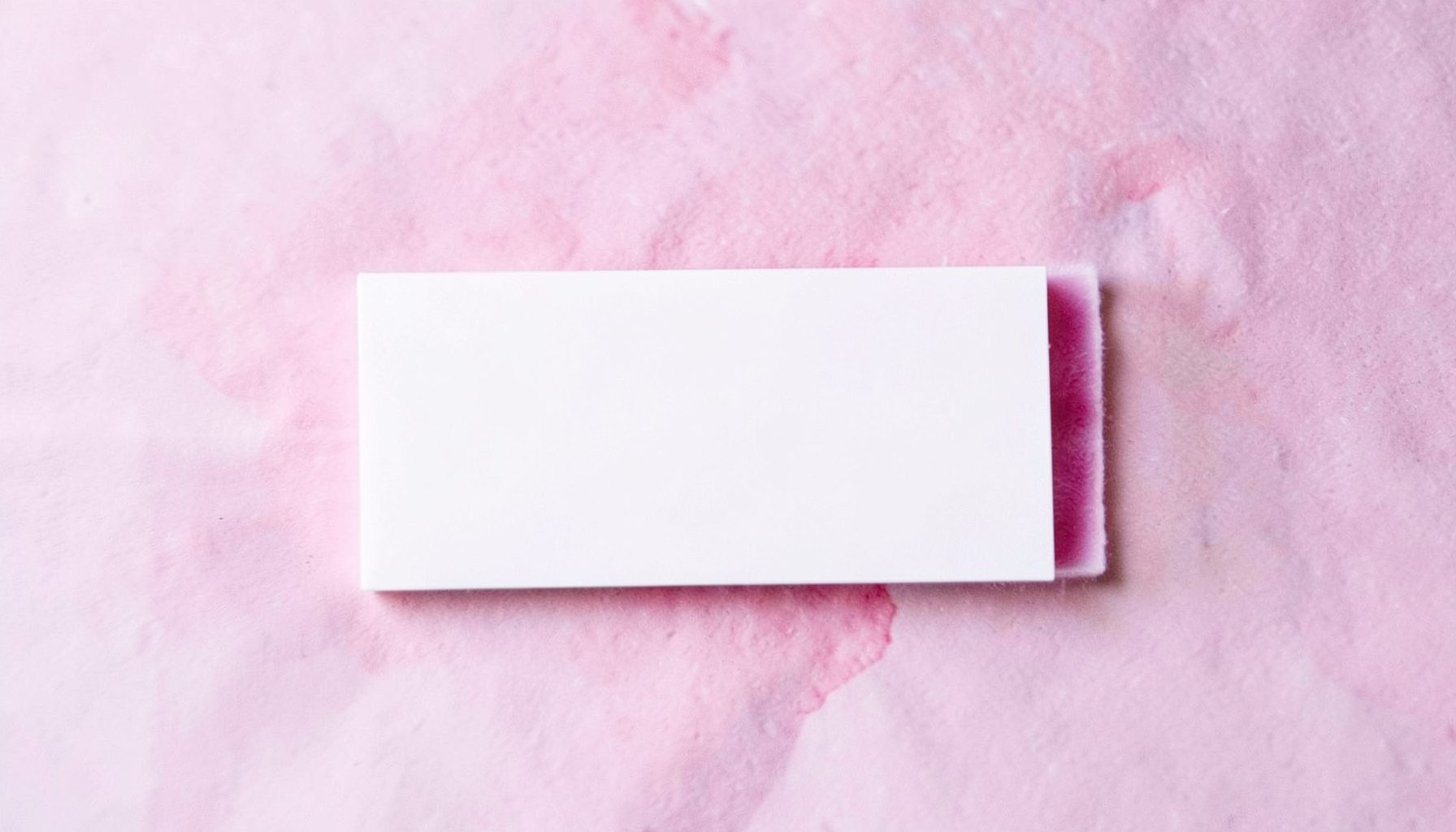 A rectangular mark in soft plum and white suggesting a health-and-education partner.